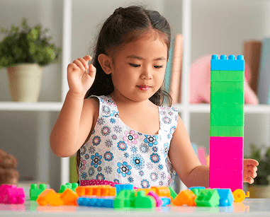 Kindergarten student playing with blocks